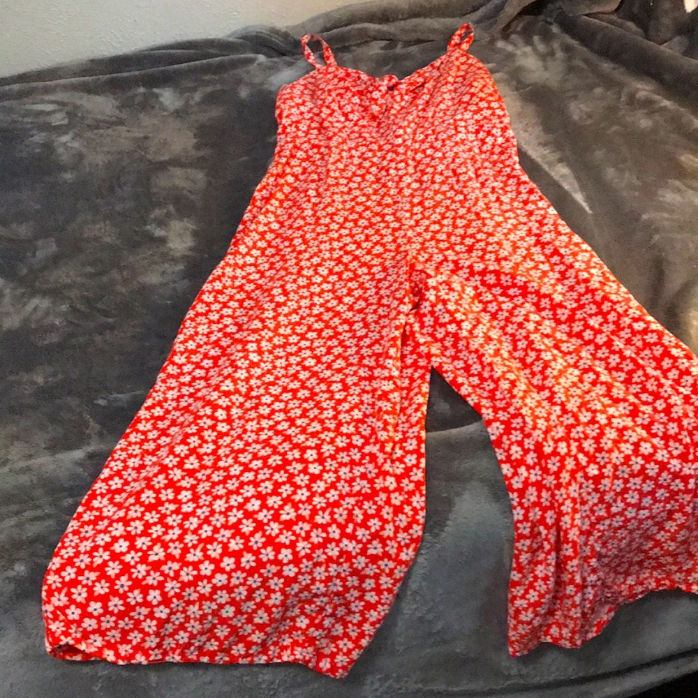 A red pant suit with flowers